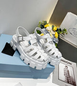 Prada Monolith crochet cage sandals, featuring a chunky lug sole and a woven, raffia-effect upper accented with the brand's signature metal triangle logo.( from 35-to 42)
