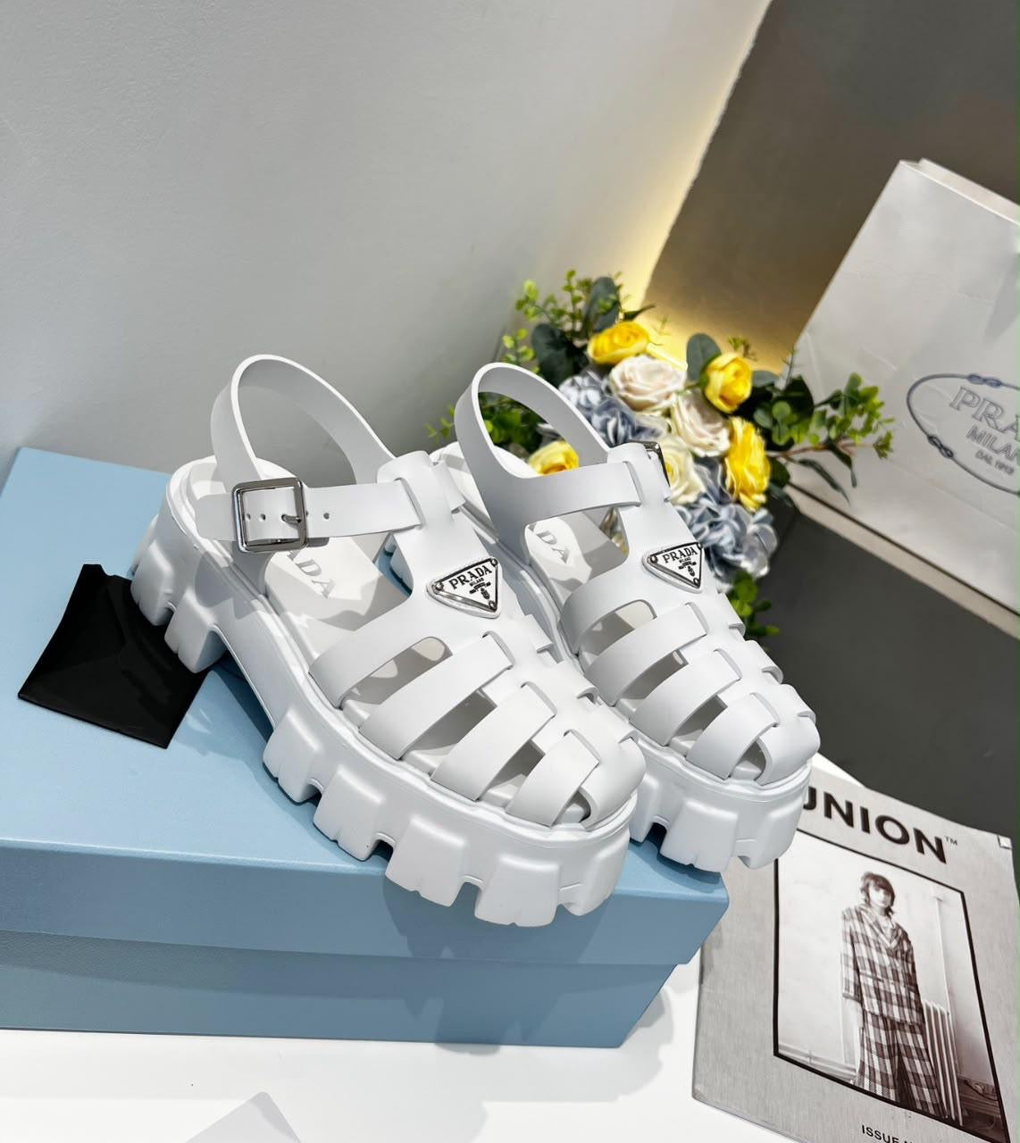 Prada Monolith crochet cage sandals, featuring a chunky lug sole and a woven, raffia-effect upper accented with the brand's signature metal triangle logo.( from 35-to 42)