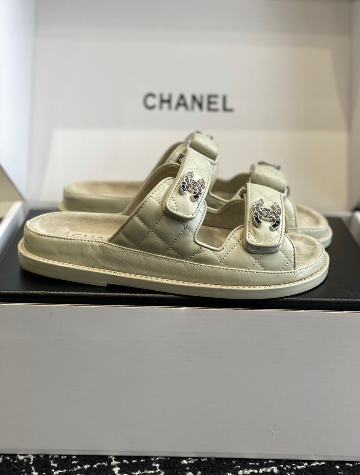 Chanel quilted lambskin dad sandals in a beige with double velcro straps and crystal-embellished CC logos