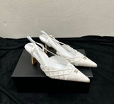 Channel slingback pumps featuring the signature embroidered CC logo on the cap toe