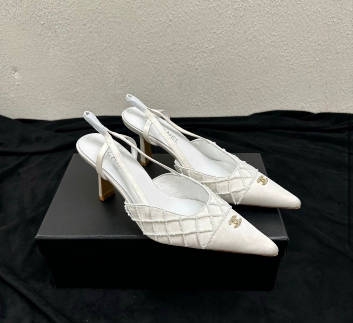 Channel slingback pumps featuring the signature embroidered CC logo on the cap toe