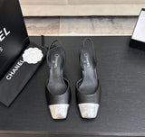 black leather slingback shoes with metallic silver cap toes featuring the signature Chanel CC logo