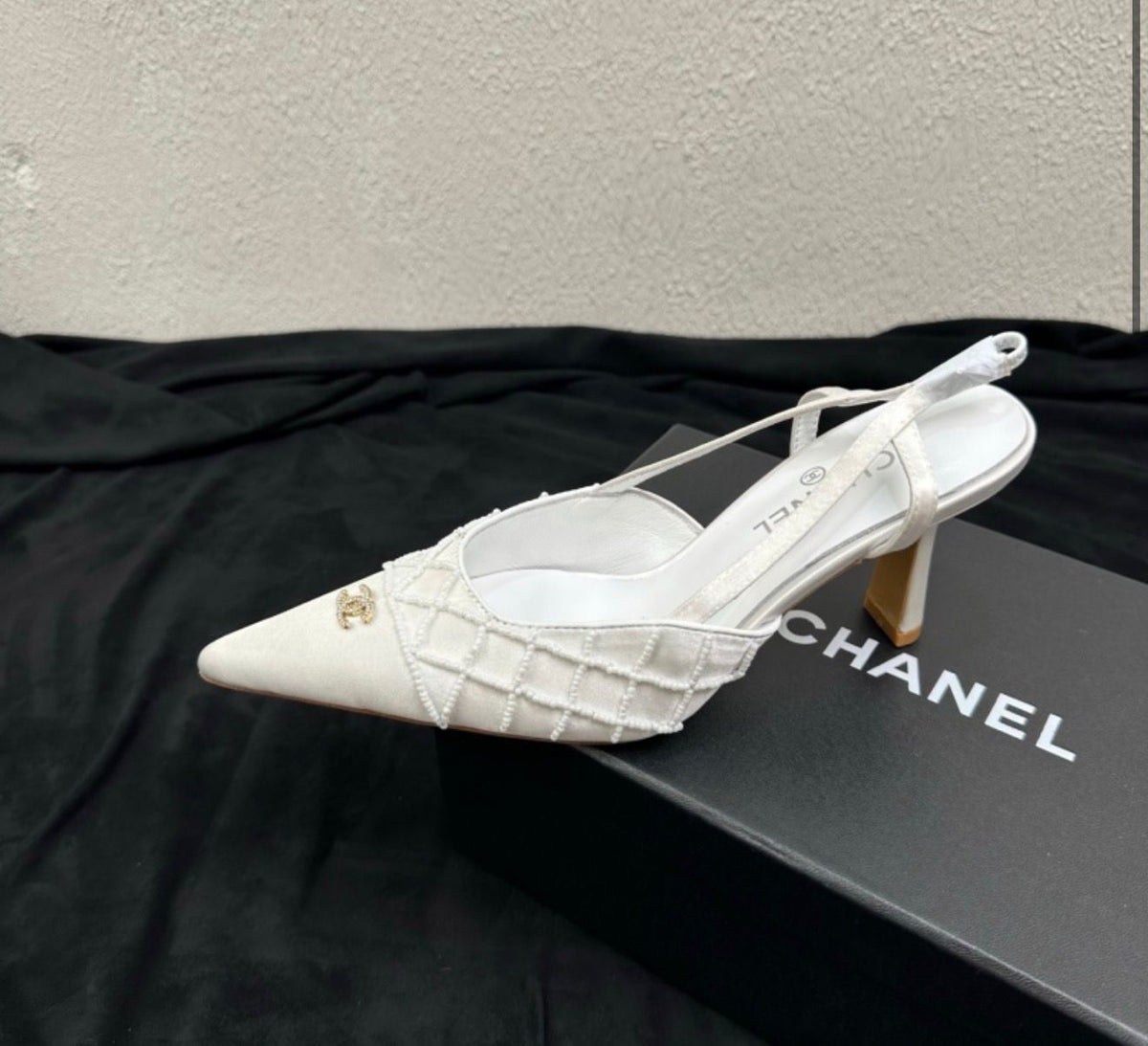Channel slingback pumps featuring the signature embroidered CC logo on the cap toe