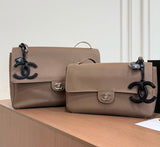 Chanel Maxi Flap Bag is crafted grained calfskin with silver metal and features a distinctive CC charm accent