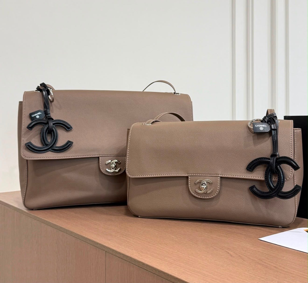 Chanel Maxi Flap Bag is crafted grained calfskin with silver metal and features a distinctive CC charm accent