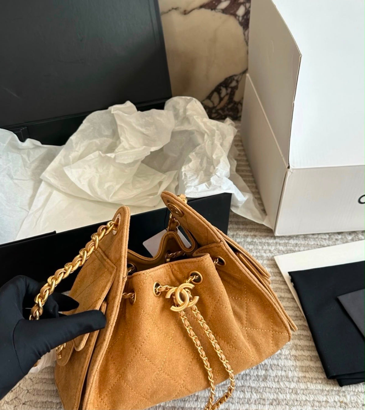 suede Chanel 25 handbags feature diamond quilting and iconic goldand silver tone CC chain drawstrings
