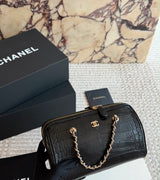 This stylish Chanel Croc-Embossed Bowling Cylinder Bag is beautifully crafted in black embossed leather with gleaming gold-tone hardware