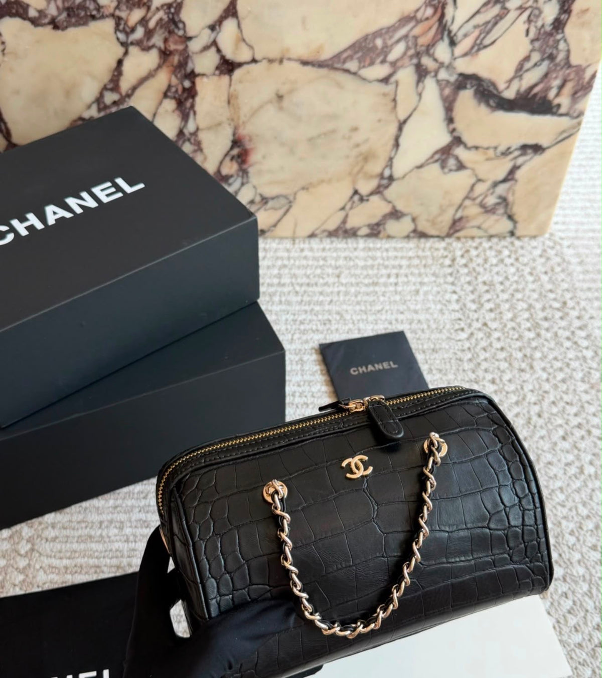 This stylish Chanel Croc-Embossed Bowling Cylinder Bag is beautifully crafted in black embossed leather with gleaming gold-tone hardware
