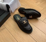 Channel Lambskin Quilted CC Turnlock Mules in black lambskin leather featuring a quilted flap front tongue and gold-tone CC metal turnlock logo