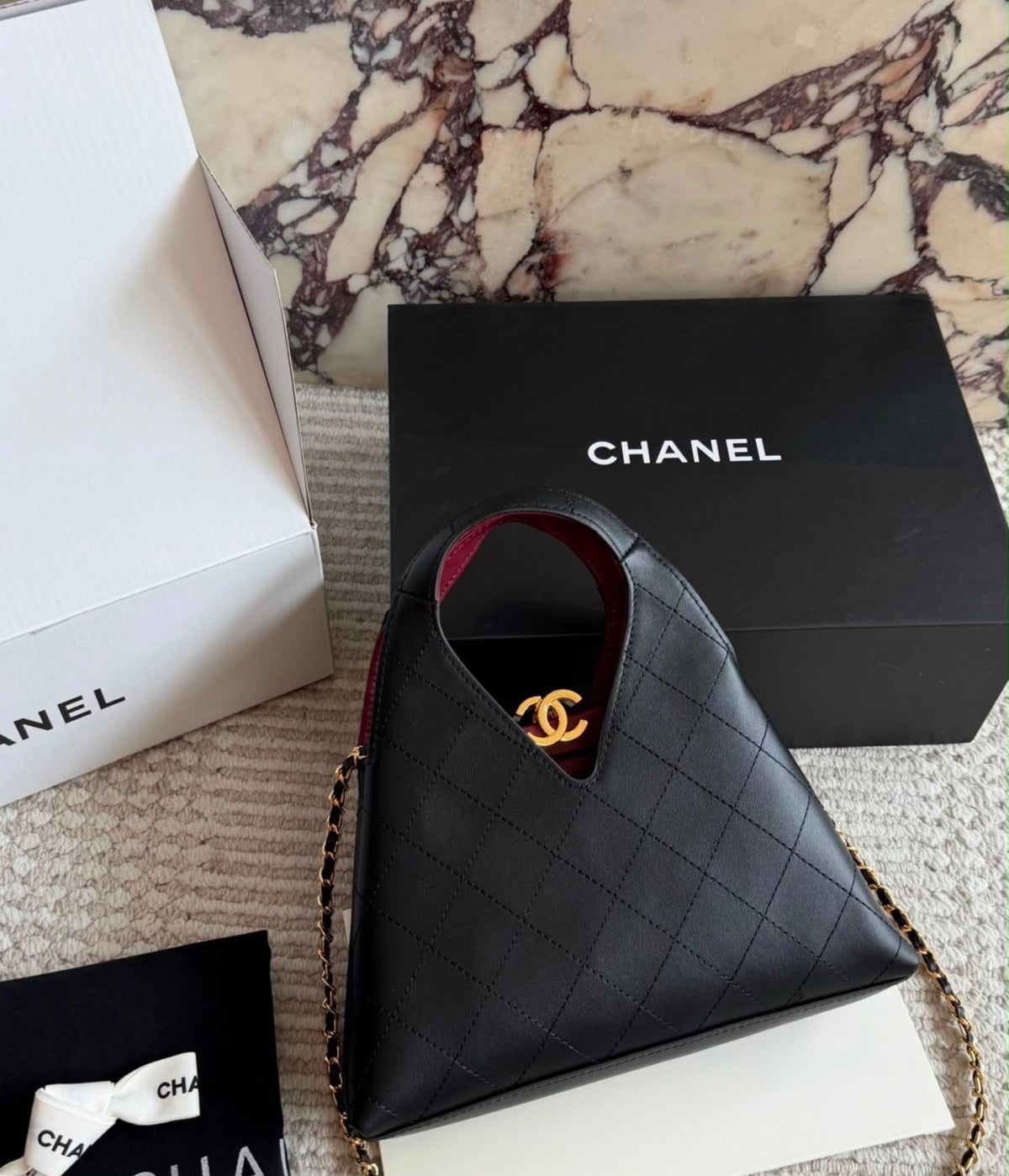 quilted calfskin Chanel shopping bag from the Métiers d'art collection features a distinctive V-cut top opening and gold-tone hardware