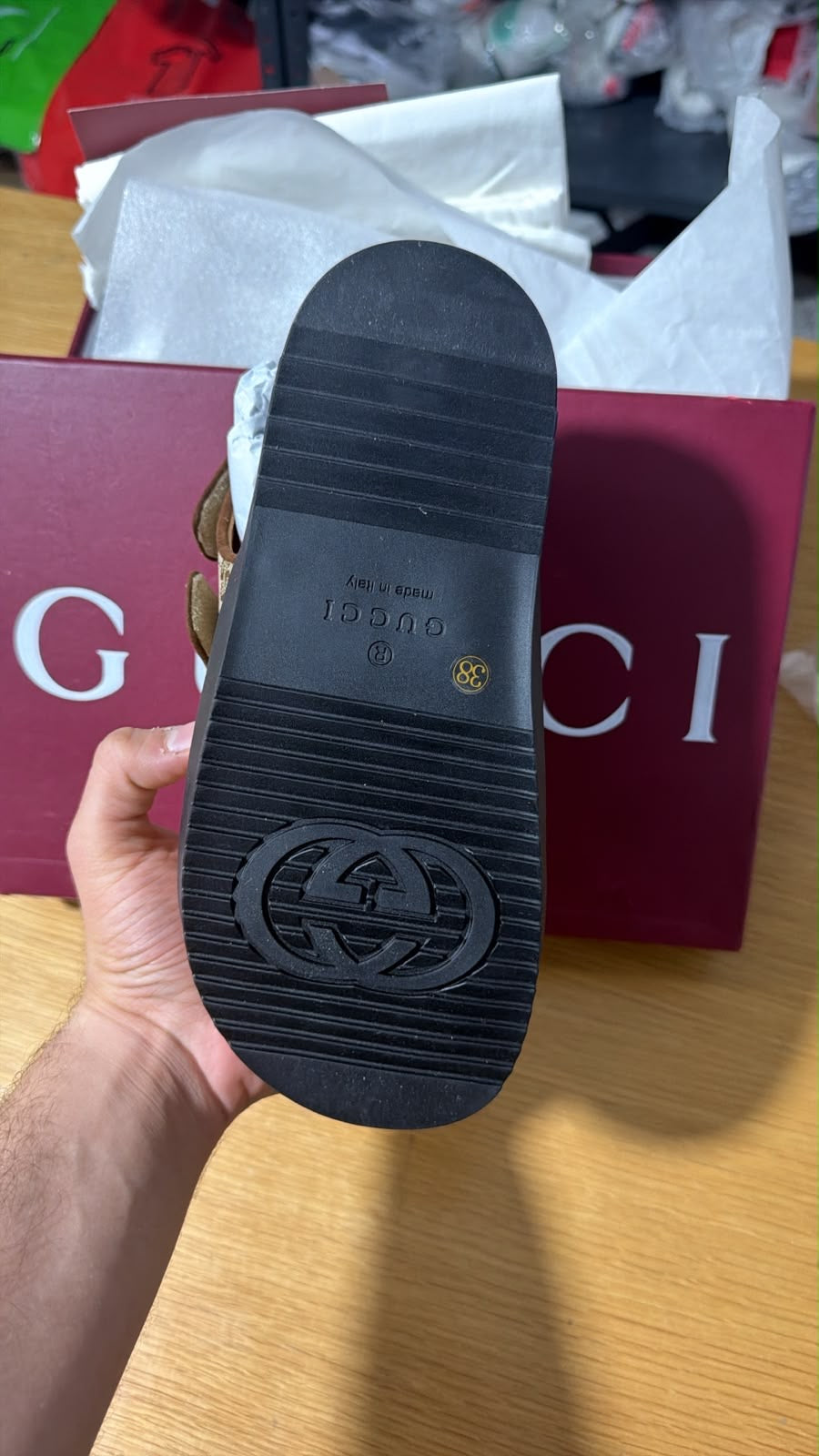 Gucci GG Supreme canvas flat sandals featuring the signature gold-toned Interlocking G hardware and adjustable velcro straps.
