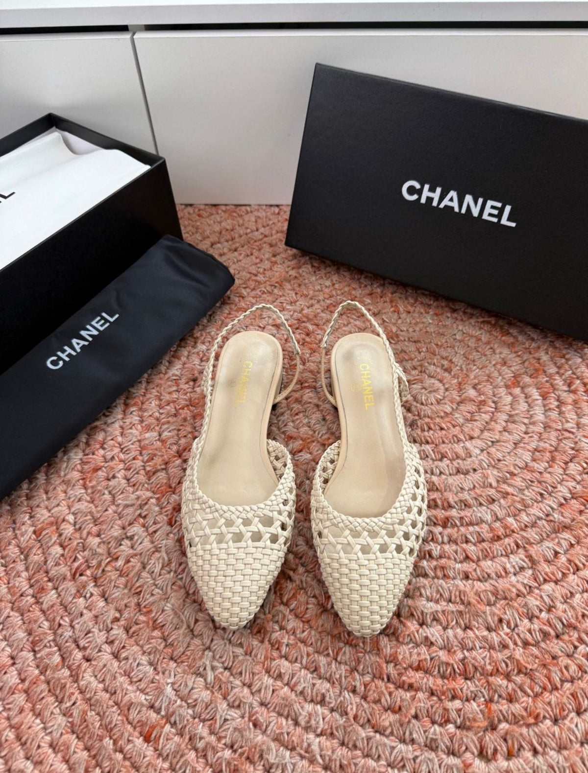 Channel woven slingback flats featuring an intricate braided design and a sleek pointed toe