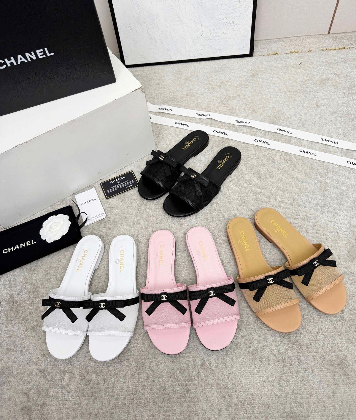 Chanel sheer mesh flat mules featuring a delicate black bow accented with the iconic CC logo