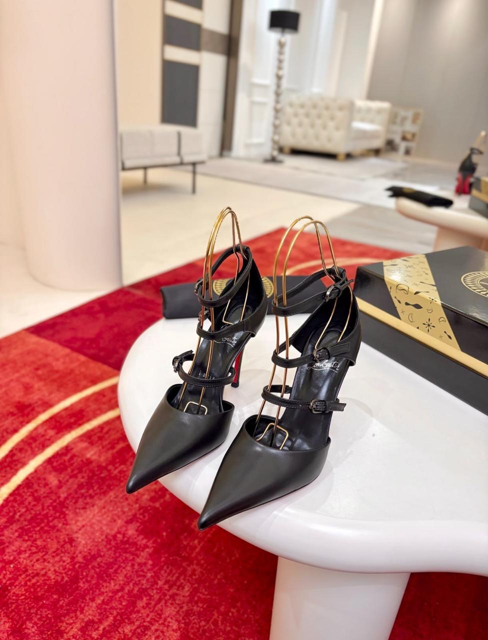 Christian Louboutin Milena pumps feature black kidskin leather and slender multi-strap buckling details