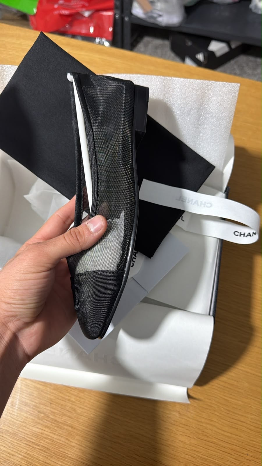 black mesh Chanel ballerina flat featuring a grosgrain cap toe with an embroidered interlocking CC logo