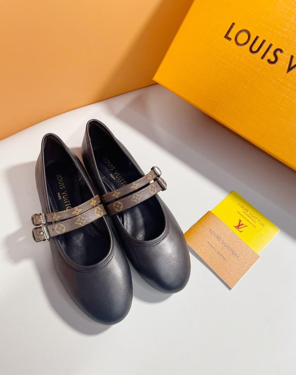 Louis Vuitton Bella Mary-Jane Ballerina in black lambskin features distinct double straps in the signature Monogram canvas with silver-toned adjustable buckles
