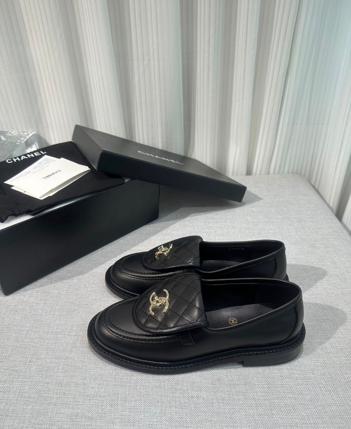 lambskin quilted CC turn-lock loafers by Chanel, featuring a quilted tongue detail with a gold-tone CC turn-lock closure