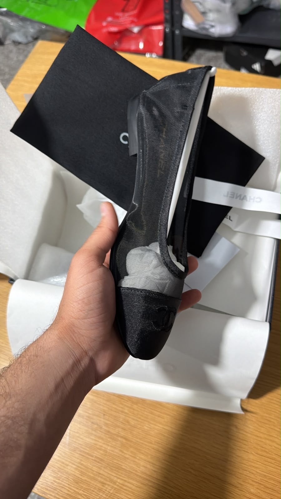 black mesh Chanel ballerina flat featuring a grosgrain cap toe with an embroidered interlocking CC logo