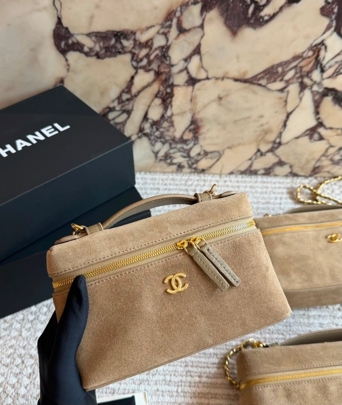 This is a Chanel Slim Long Vanity Case with Chain suede featuring gold tone hardware