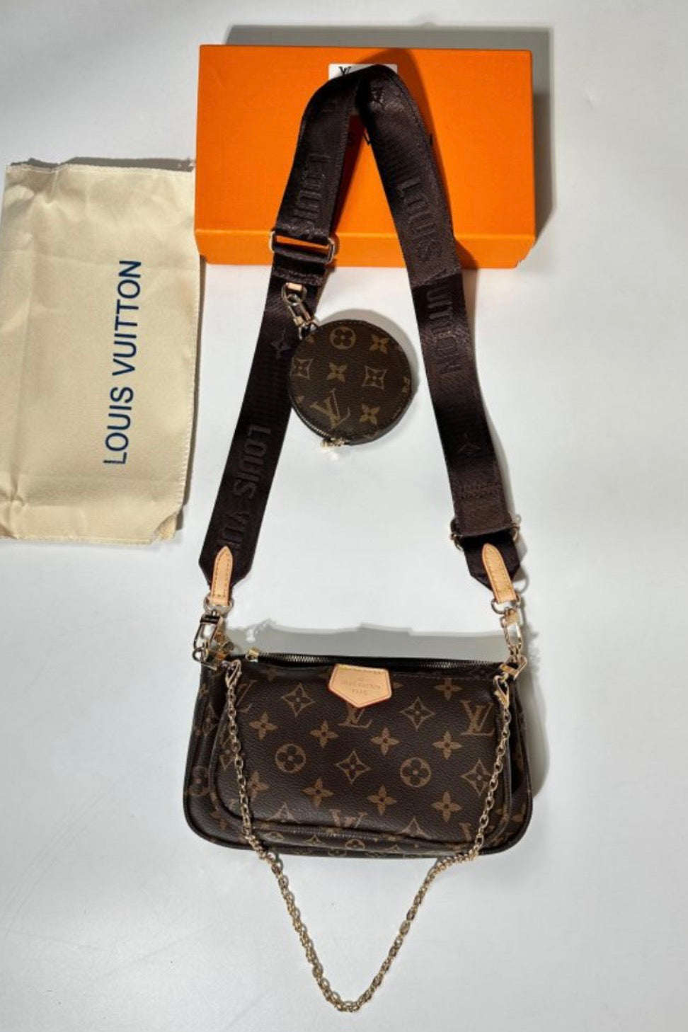 Louis Vuitton Multi Pochette Accessoires bag, featured in the classic brown Monogram canvas with a detachable dark brown strap and gold-tone chain link.