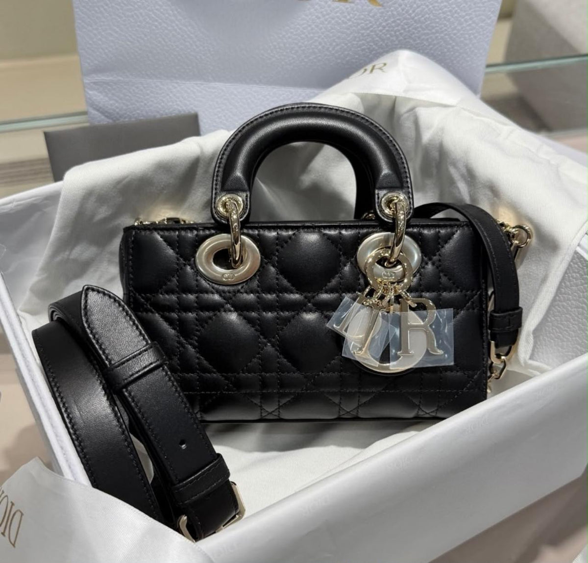 Dior Lady D-Joy micro bag in black cannage lambskin, featuring classic quilted stitching and pale gold-finish charms