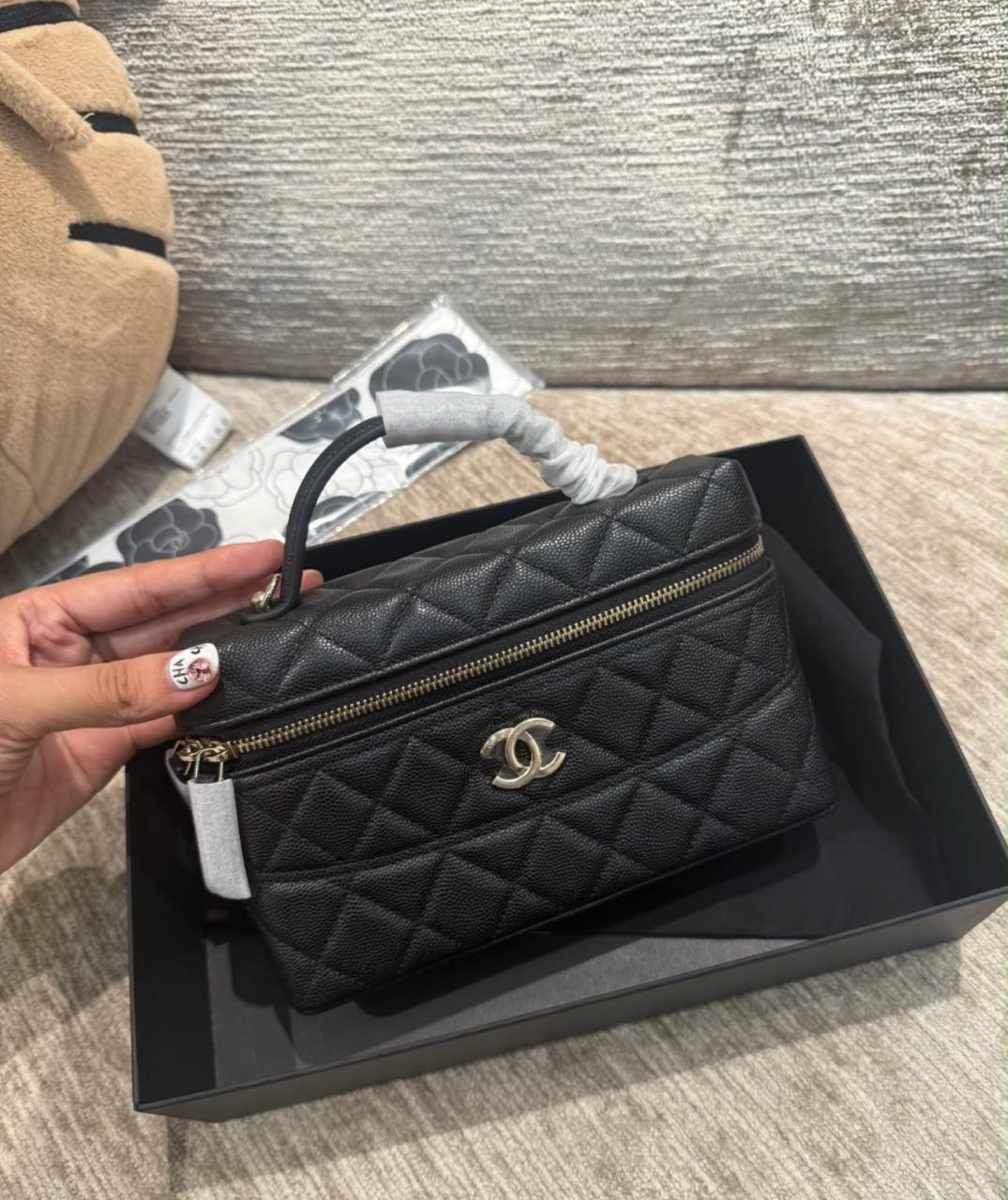 Chanel black caviar quilted slim vanity bag featuring the signature interlocking CC logo on the front