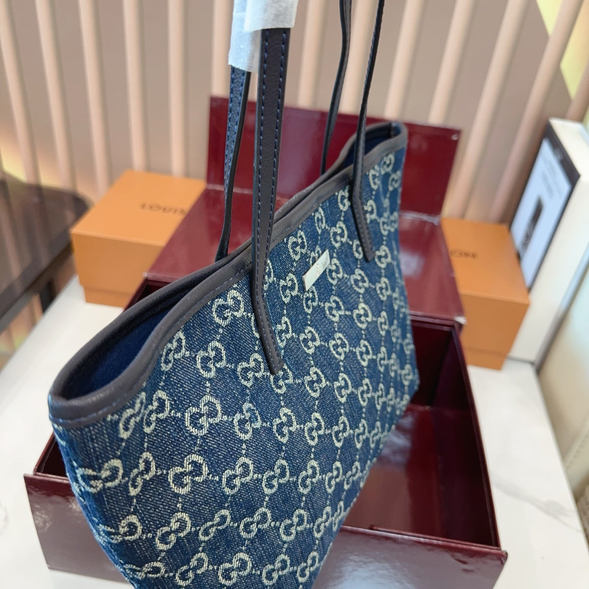 Comes with a box measuring 25*20 cm. This Gucci denim tote bag features GG Supreme monogram canvas with leather trim and handles, and a gold-tone metal logo plate. The bag has Gucci's classic structured tote silhouette, understated yet stylish, suitable for everyday wear without being too formal. (Ej)